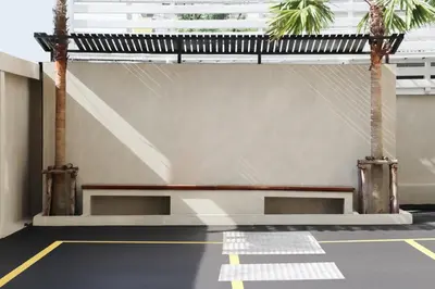 a room with two palm trees and a bench at UTD8 Hotel and Residence in Bangkok