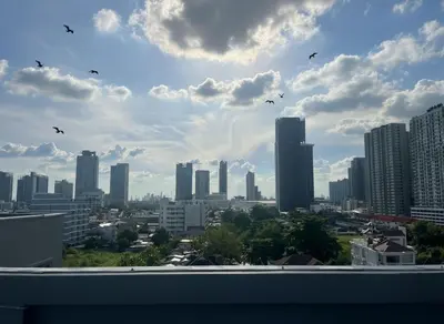a view of a city with birds flying in the sky at UTD8 Hotel and Residence in Bangkok