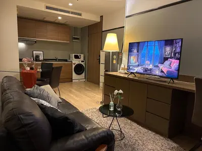 a living room with a couch and a flat screen tv at Noble Remix Thong Lo Long Stay Cozy&Warm Direct access to BTS Pool Gym WiFi in Bangkok