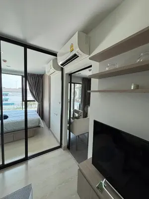 a room with a bed and a tv and a bedroom at Sukhumvit 50 apartment in Bangkok