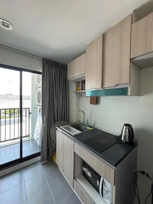 a kitchen with a sink and a counter top at Sukhumvit 50 apartment in Bangkok