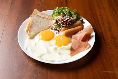 a plate of breakfast food with eggs and toast at Dewan Bangkok in Bangkok