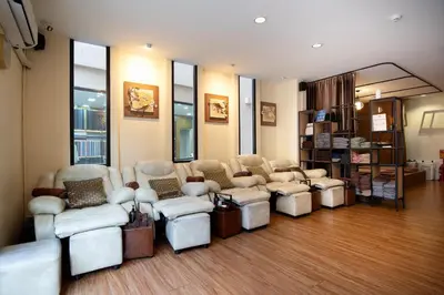 a waiting room with couches and chairs in a store at Dewan Bangkok in Bangkok