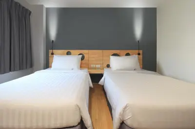 two beds sitting next to each other in a room at Mybed Sathorn Hotel in Bangkok