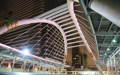 a view of a large building with a bridge at Mybed Sathorn Hotel in Bangkok