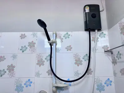 a bathroom with a blow dryer on the wall at Onnut36 Apartment Panasan in Amphoe Phra Khanong