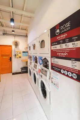 a laundry room with washing machines and posters on the wall at Rose Loft Family or friends 6 person in Thonhuri