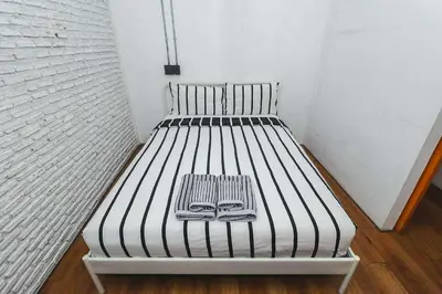 a bed with a book on it in a room at Rose Loft Family or friends 6 person in Thonhuri