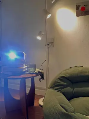 a room with a table with a lamp and a couch at Roni House Thonglor in Bangkok