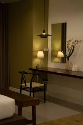 a room with a desk with a mirror and a chair at Roni House Thonglor in Bangkok