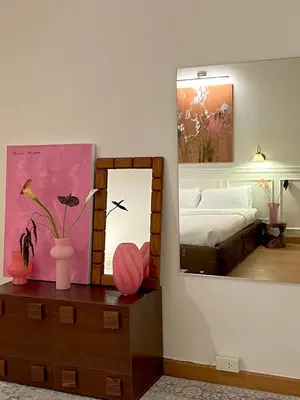 a bedroom with a bed and a mirror on a dresser at Roni House Thonglor in Bangkok