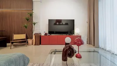 a living room with a tv and a glass floor at Roni House Thonglor in Bangkok