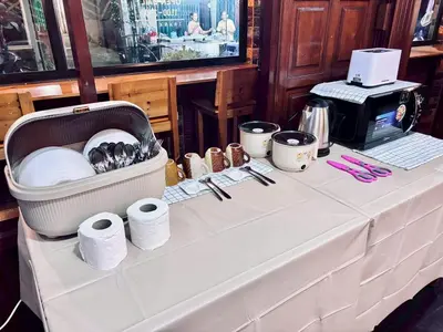 a table with a white table cloth with rolls of toilet paper at Sukhum Ban Songthai in Bangkok
