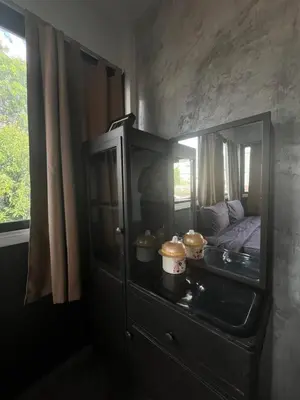 a bedroom with a glass cabinet with a bed in it at BNK89 Hostel in Bangkok