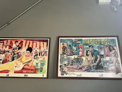 two movie posters hanging on a wall at BNK89 Hostel in Bangkok