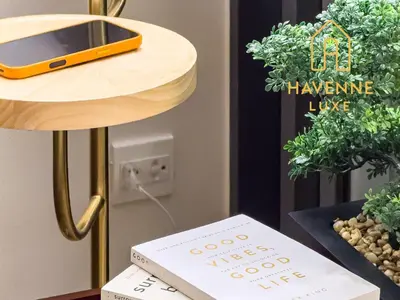 a book on a table with a phone on top of it at City Luxe Condo 5-Min Walk to Siam Paragon Modern Stay in Bangkok