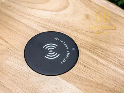 a black disc sitting on top of a wooden table at City Luxe Condo 5-Min Walk to Siam Paragon Modern Stay in Bangkok