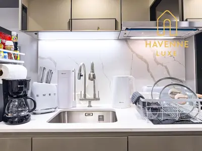 a kitchen counter with a sink and a mixer at City Luxe Condo 5-Min Walk to Siam Paragon Modern Stay in Bangkok