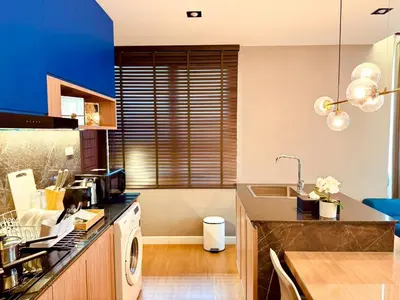 a kitchen with a sink and a washing machine at The Prestige Living Bangkok at Sathorn-Chan in Bangkok