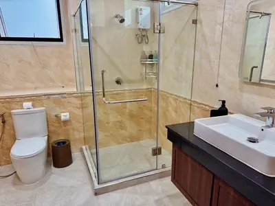 a bathroom with a shower and a toilet and a sink at The Prestige Living Bangkok at Sathorn-Chan in Bangkok