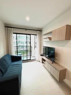 a living room with a couch and a flat screen tv at Bangkok apartment in Bangkok