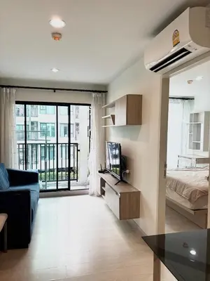a living room with a couch and a bed and a television at Bangkok apartment in Bangkok