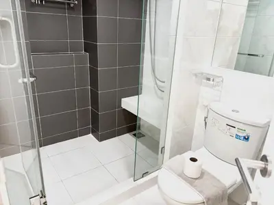 a bathroom with a toilet and a glass shower at Bangkok apartment in Bangkok