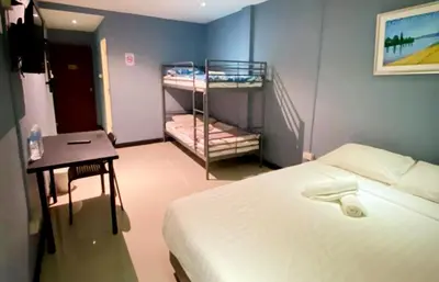 a small room with a bed and a staircase at The Little Pig Sukhumvit in Bangkok