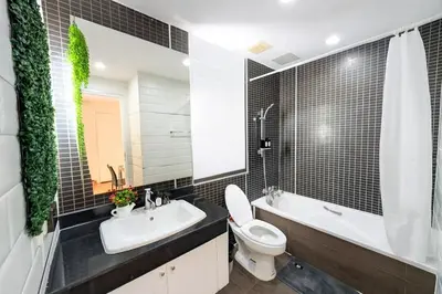 a bathroom with a toilet and a sink and a tub at New Renovated 2 Beds Amazing Balcony View Nana BTS in Bangkok