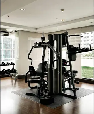 a gym with several treadmills and tread machines at Cozy Urban Retreat in Sukhumvit Steps to BTS Nana in Bangkok
