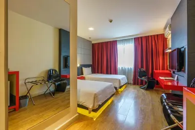 a hotel room with a bed and a television at The Park Residence in Bangkok
