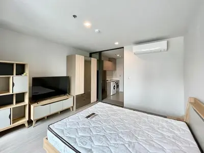 a large room with a bed and a television at 1 bedroom Life Ladprao in Bangkok