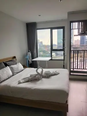 a bedroom with a bed with a ribbon on it at 1 bedroom Life Ladprao in Bangkok