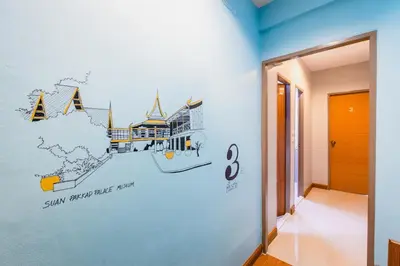 a hallway with a wall mural of a map of the world at Restiny Hostel in Bangkok