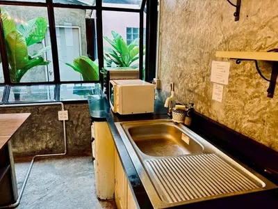 a kitchen with a sink and a window at Sukhum Victorymonument-Ari in Bangkok