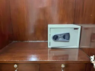 a small white microwave sitting on top of a wooden cabinet at Sukhumvit soi 4 Apartment Center of BKK in Bangkok