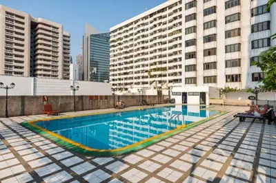a swimming pool in a city with tall buildings at Sukhumvit soi 4 Apartment Center of BKK in Bangkok