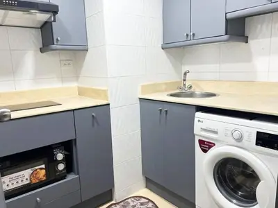 a kitchen with a washing machine and a sink at Sukhumvit soi 4 Apartment Center of BKK in Bangkok