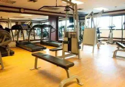 a gym with several treadmills and machines in it at Sukhumvit soi 4 Apartment Center of BKK in Bangkok