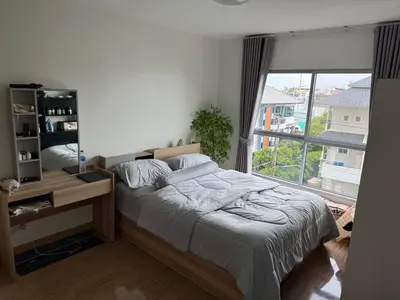 a bedroom with a bed and a large window at 1 bd at s&s sukhumbit in Amphoe Phra Khanong