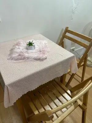a table with a pink blanket and a plant on it at Ally home 14 06 in Thung Si Kan
