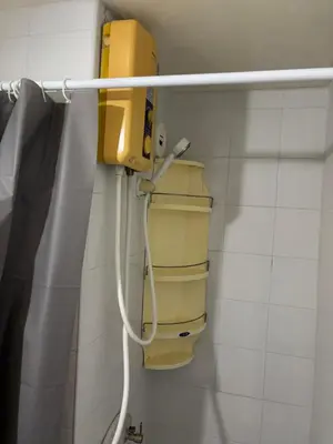 a bathroom with a yellow box on the wall at Ally home 14 06 in Thung Si Kan