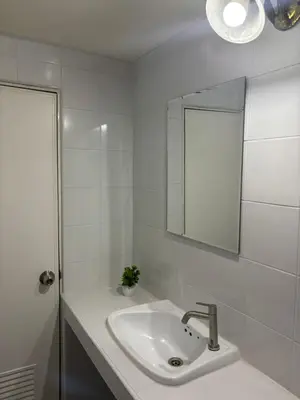 a white bathroom with a sink and a mirror at Ally home 14 06 in Thung Si Kan