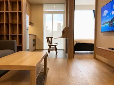 a living room with a couch and a table at Urban Oasis BTS Ekkamai in Khlong Toei