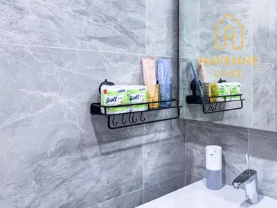 a bathroom with two shelves above a sink at New City Condo in Central Bangkok in Pratunam