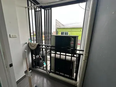 a room with a balcony with a television and a window at Cozy Room - On Nut - Wi-Fi, Gym, Pool in Bangkok