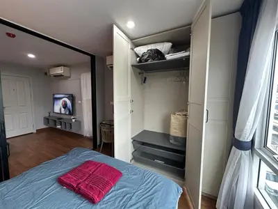 a bedroom with a bed with a red towel on it at Cozy Room - On Nut - Wi-Fi, Gym, Pool in Bangkok