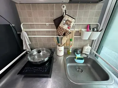 a kitchen counter with a sink and a bowl on a stove at Cozy Room - On Nut - Wi-Fi, Gym, Pool in Bangkok
