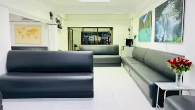 a waiting room with a couch and a table at Bangkok-Pratunam Hotel in Bangkok
