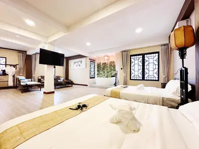 a hotel room with two beds and a flat screen tv at Chinatown No9 Boutique Hotel in Bangkok